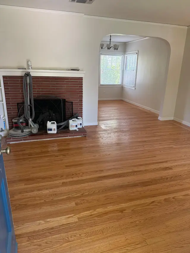 Refinished red oak hardwood floors gleaming in a Fair Oaks living room