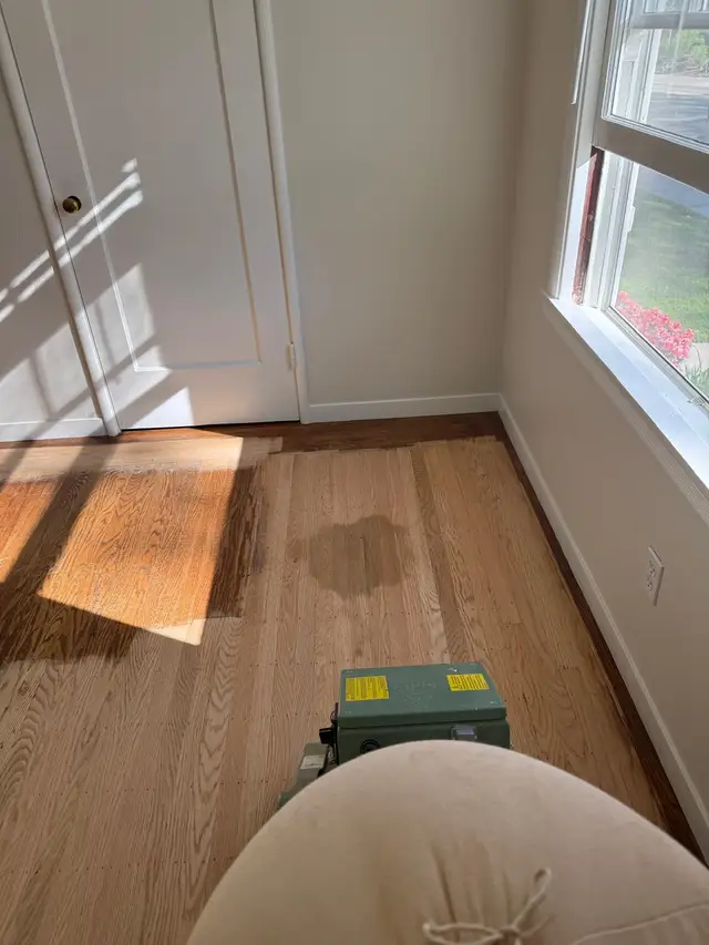 Hardwood floor refinishing in progress, oak floor sanded to bare wood in Fair Oaks