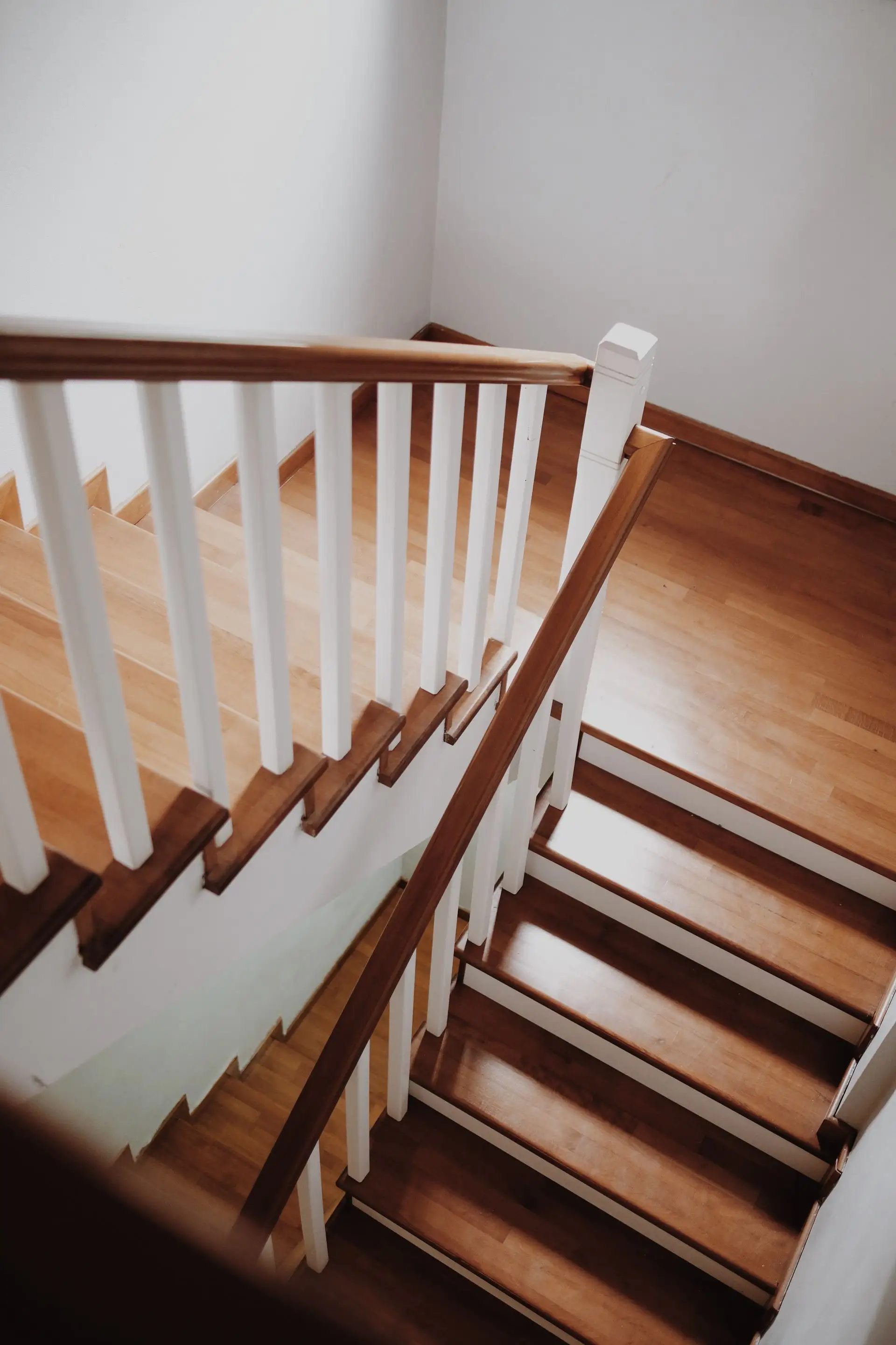 Oak staircase with white balusters seen from the landing