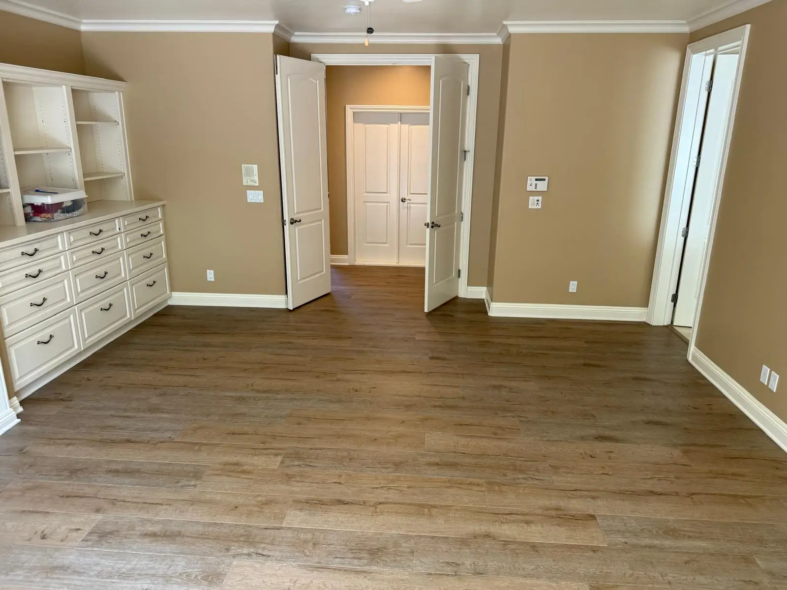 Wide-plank LVP vinyl flooring installation in a Antelope home with built-in shelving
