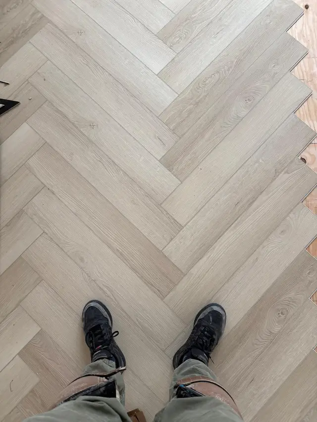 Herringbone luxury vinyl plank flooring installation in progress in a North Highlands home