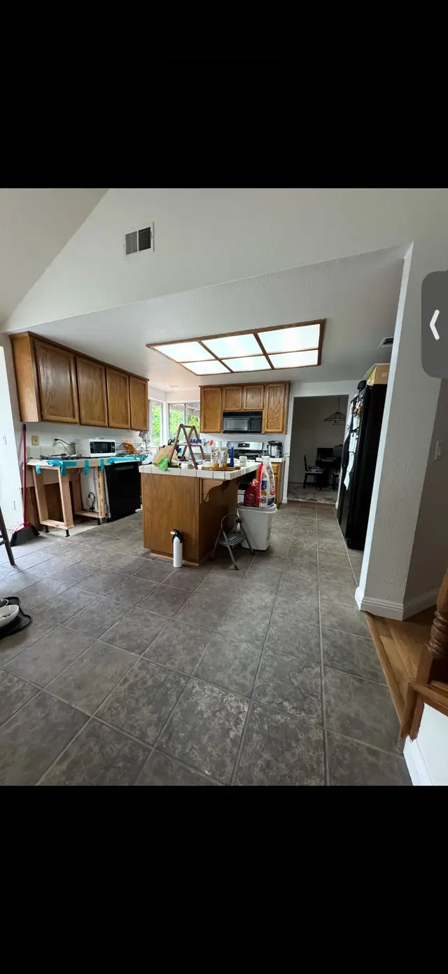 Before photo of a tile kitchen floor ahead of LVP flooring installation