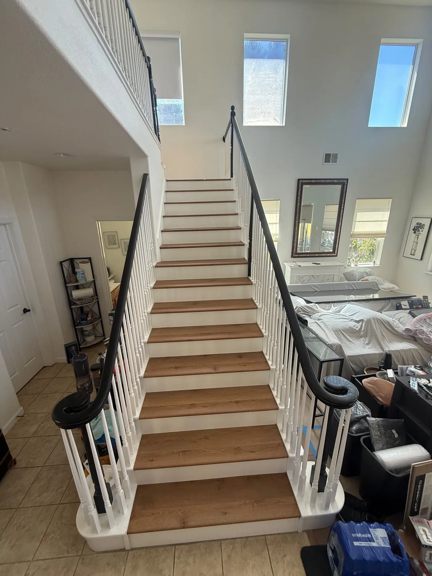 After: Bare plywood staircase finished with warm oak treads and crisp white risers