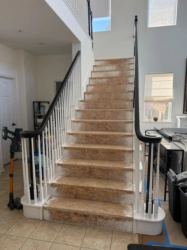 Before: Bare plywood staircase finished with warm oak treads and crisp white risers