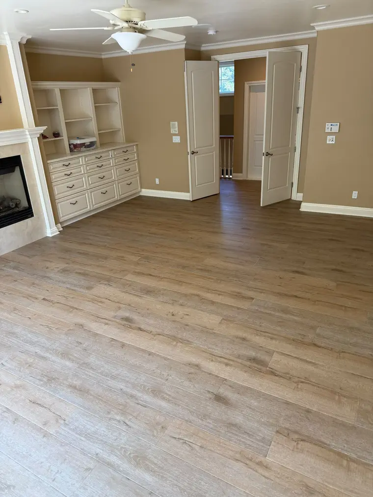 After: Master bedroom leveled and finished with wide plank luxury vinyl