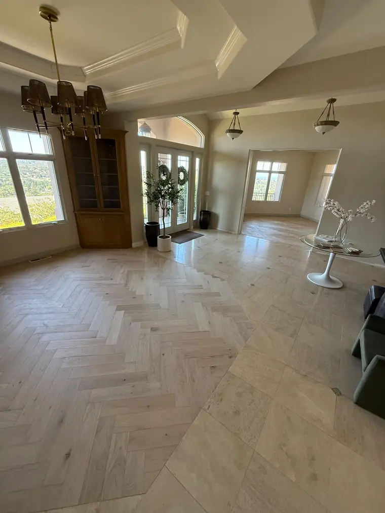 After: White oak herringbone installed over a fresh subfloor in the front room