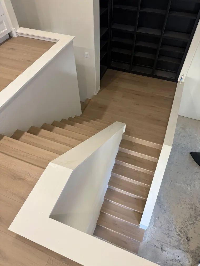 After: Subfloor stairs and landing transformed with light oak plank flooring