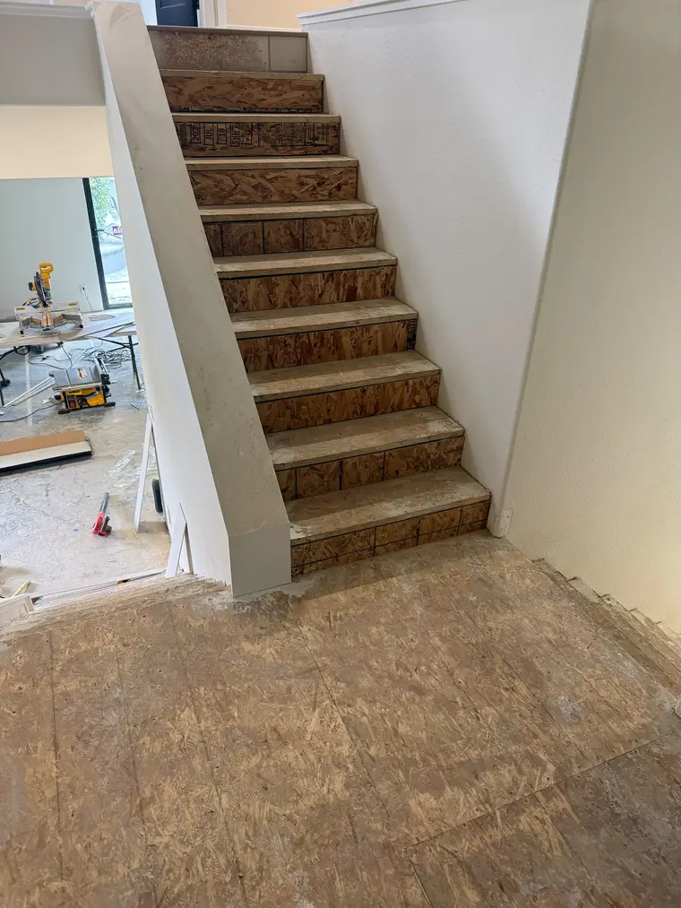 Before: Subfloor stairs and landing transformed with light oak plank flooring