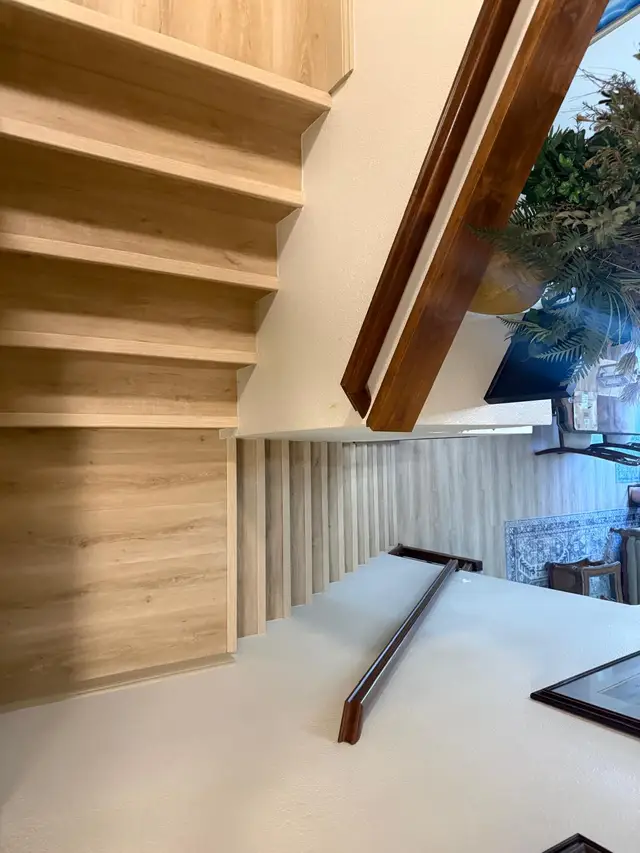 Vinyl plank flooring installation on stairs and landing, photo rotated sideways
